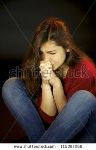 stock-photo-scared-young-woman-crying-and-praying-115397068